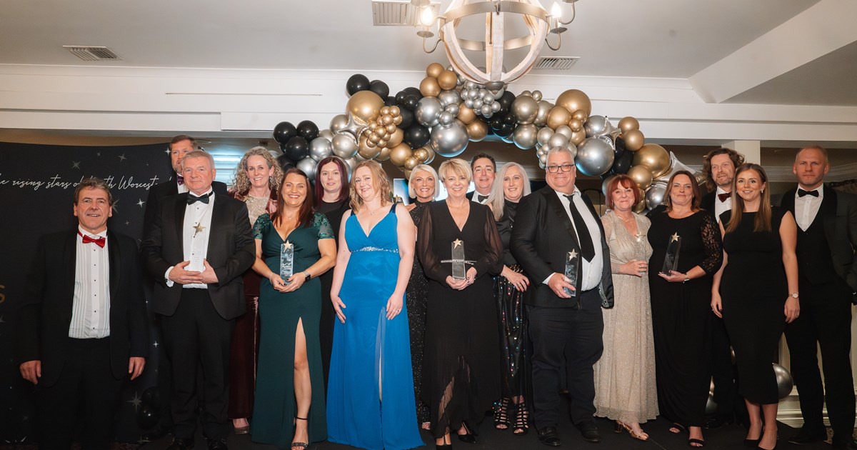 group of people dressed up to attend an award evening wearing black tie attire and cocktail dresses